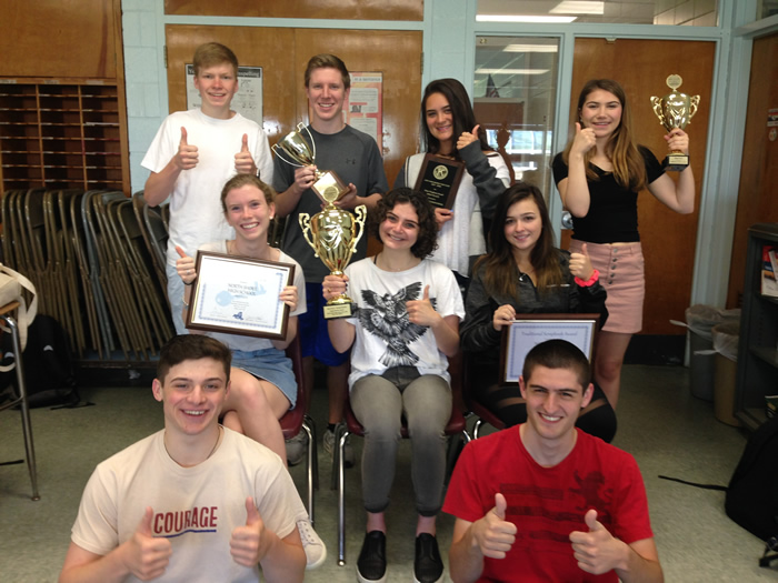 Students iin Key Club with trophies