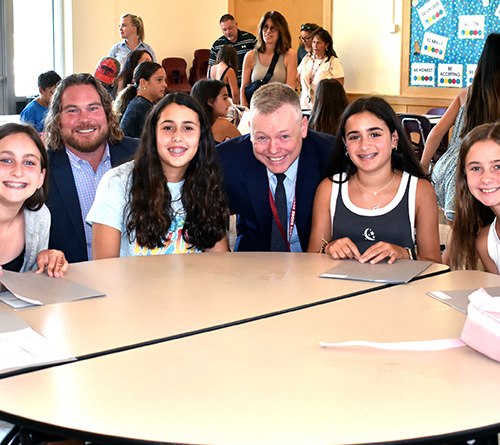 Students and Principal sitting at a table