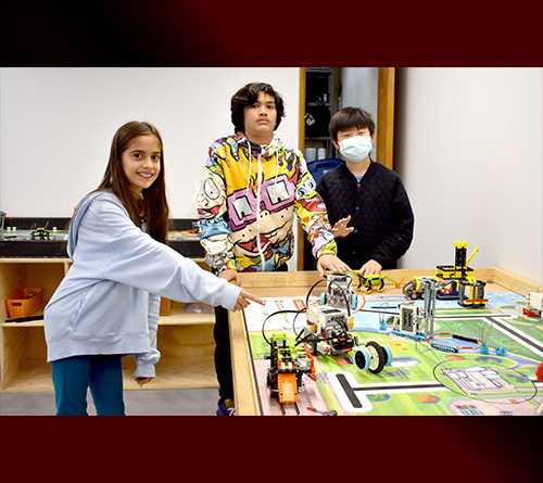 Students Surrounding Robotics Table
