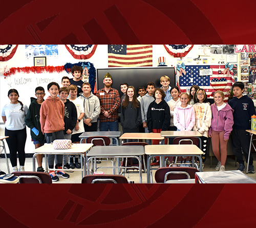 Students and Principal sitting at a table