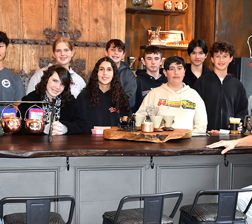 Students at the table smiling for a photo