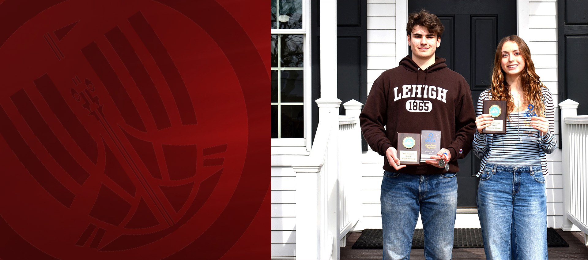 Two students standing on a front porch holding DECA awards and medals, smiling after a competition achievement.