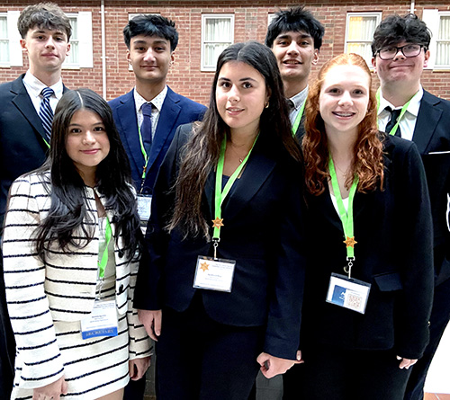 Group of students in formal attire posing at a leadership or academic event