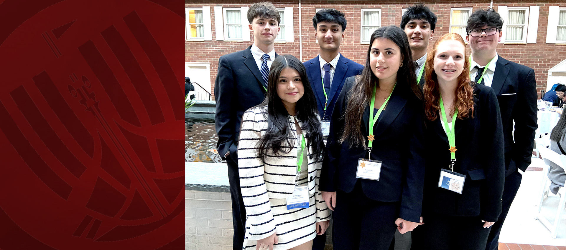 Group of students in formal attire posing at a leadership or academic event