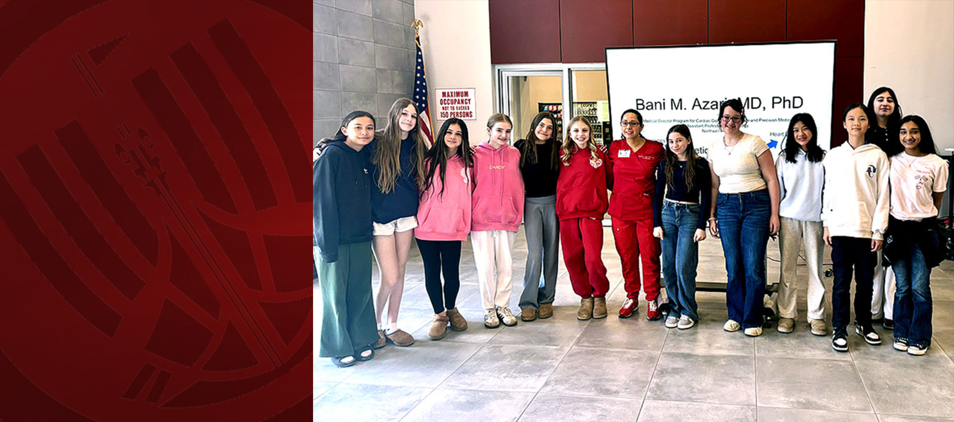 Group of students standing with a speaker during a medical career presentation indoors