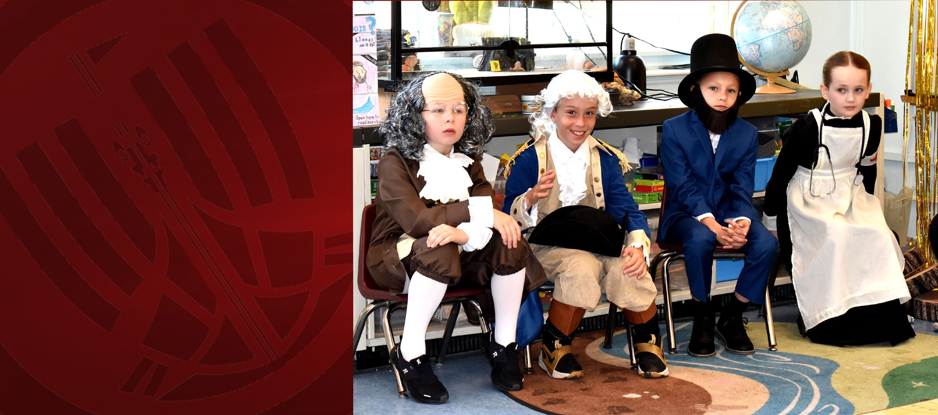 Students dressed as historical figures sit in a classroom during a third-grade wax museum presentation, wearing costumes inspired by famous people from history.