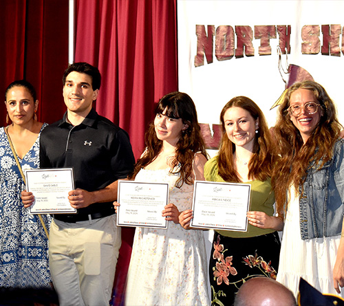 Students and teachers posing with certificates during a North Shore school recognition event.