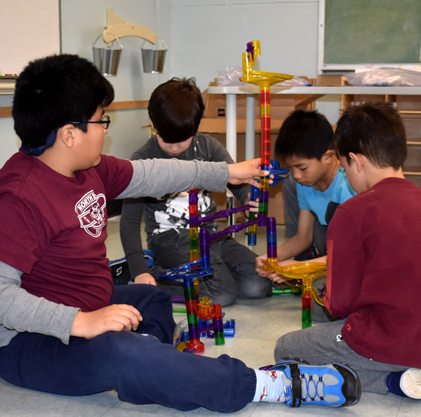 Students Sitting on The Floor Building