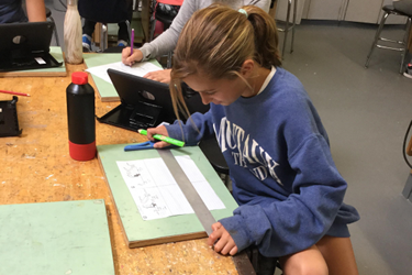 girl using a ruler on graph paper