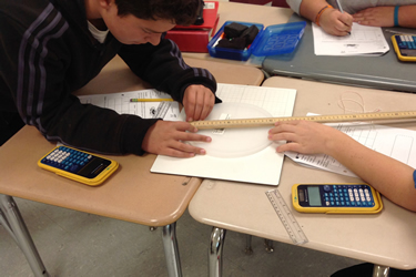 student with calcuator and ruler