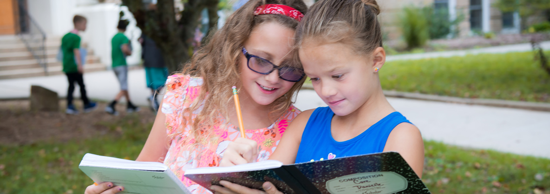 two students with notebooks