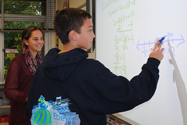 boy woking on a white board